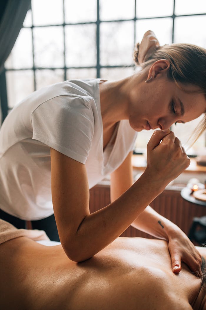 Home A relaxing massage therapy session indoors with a focus on body care and self-care.