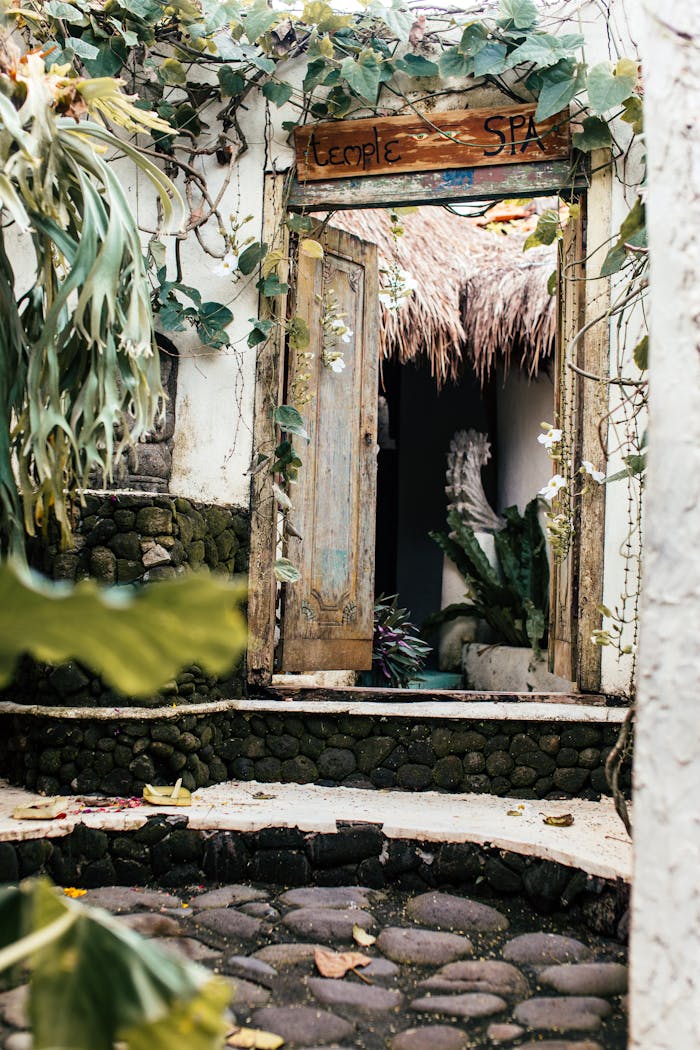 Home Rustic spa entrance with ivy and tropical ambiance, inviting doorway into relaxation.